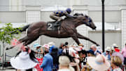 Race fans enter the track beneath the statue of Secretariat on Kentucky Derby Day at Churchill Downs in 2023.