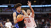Duke’s Cameron Boozer drives to the basket against Arkansas forward Malique Ewin on Thanksgiving.