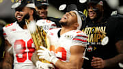 Ohio State Buckeyes running back TreVeyon Henderson celebrates with the trophy following the 34-23 win over Notre Dame.