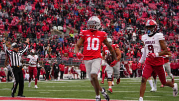 Nov 12, 2022; Columbus, Ohio, USA; Ohio State Buckeyes wide receiver Xavier Johnson (10) scores a touchdown past Indiana Hoosiers defensive back Brylan Lanier (9) on a 71-yard run during the second half of the NCAA football game at Ohio Stadium. Ohio State won 56-14. Mandatory Credit: Adam Cairns-The Columbus Dispatch

Ncaa Football Indiana Hoosiers At Ohio State Buckeyes