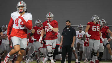 Mar 7, 2024; Columbus, OH, USA; Ohio State Buckeyes head coach Ryan Day watches players warm up during spring football practice at the Woody Hayes Athletic Center.