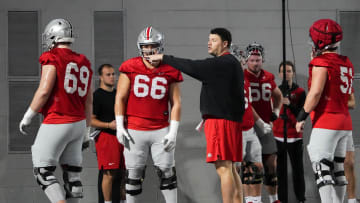 Mar 7, 2024; Columbus, OH, USA; Ohio State Buckeyes offensive line coach Justin Frye works with offensive lineman Enokk Vimahi (66) and offensive lineman Ian Moore (69) during spring football practice at the Woody Hayes Athletic Center.