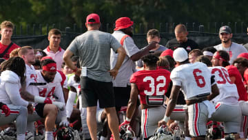 Aug 8, 2024; Columbus, Ohio, USA; Ohio State Buckeyes head coach Ryan Day and defensive line coach Larry Johnson address the team during football practice at the Woody Hayes Athletic Complex.