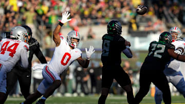 Oct 12, 2024; Eugene, Oregon, USA; Ohio State Buckeyes linebacker Cody Simon (0) pressures Oregon Ducks quarterback Dillon Gabriel (8) during the first half of the NCAA football game at Autzen Stadium