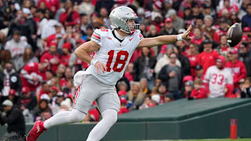 Ohio State Buckeyes quarterback Will Howard (18) makes a shovel pass during the second half of the NCAA football game against the Northwestern Wildcats at Wrigley Field in Chicago on Saturday, Nov. 16, 2024. Ohio State won 31-7.
