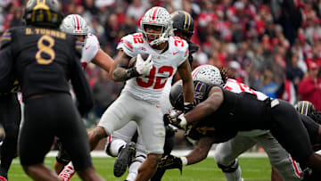 Ohio State Buckeyes running back TreVeyon Henderson (32) runs during the first half of the NCAA football game against the Northwestern Wildcats at Wrigley Field in Chicago on Saturday, Nov. 16, 2024.