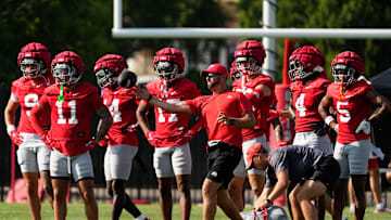 Aug 1, 2024; Columbus, OH, USA; Ohio State Buckeyes co-offensive coordinator Brian Hartline throws passes to his wide receivers during football camp at the Woody Hayes Athletic Complex.