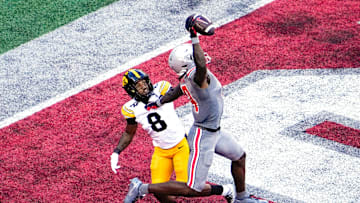 Oct 5, 2024; Columbus, Ohio, USA; Ohio State Buckeyes wide receiver Jeremiah Smith (4) makes a one-handed touchdown catch against Iowa Hawkeyes defensive back Deshaun Lee (8) in the third quarter at Ohio Stadium on Saturday.