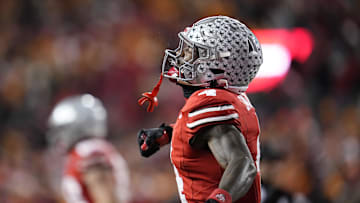 Dec 21, 2024; Columbus, Ohio, USA; Ohio State Buckeyes wide receiver Jeremiah Smith (4) celebrates after a touchdown catch against the Tennessee Volunteers during the second half of the College Football Playoff first round game at Ohio Stadium. Ohio State won 42-17. Mandatory Credit: Adam Cairns-Imagn Images