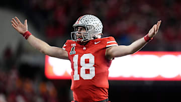 Ohio State Buckeyes quarterback Will Howard (18) celebrates a touchdown by running back TreVeyon Henderson during the second half of the College Football Playoff first round game against the Tennessee Volunteers at Ohio Stadium in Columbus on Dec. 22, 2024. Ohio State won 42-17.