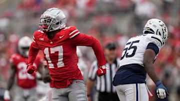 Aug 31, 2024; Columbus, OH, USA; Ohio State Buckeyes linebacker Mitchell Melton (17) celebrates behind Akron Zips offensive lineman Josh Blanchard (55) during the second half of the NCAA football game at Ohio Stadium. Ohio State won 52-6.