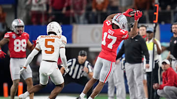 Ohio State Buckeyes wide receiver Carnell Tate (17) makes a sideline catch in front of Texas Longhorns defensive back Malik Muhammad (5) during the first half of the Cotton Bowl Classic College Football Playoff semifinal game at AT&T Stadium in Arlington, Texas on Jan. 10, 2025.