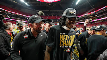Ohio State Buckeyes head coach Ryan Day and Ohio State Buckeyes wide receiver Jeremiah Smith (4) leave the field following the 34-23 win over the Notre Dame Fighting Irish to win the College Football Playoff National Championship at Mercedes-Benz Stadium in Atlanta on Jan. 21, 2025.
