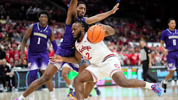 Ohio State Buckeyes guard Bruce Thornton (2) dribbles past Washington Huskies guard Mekhi Mason (0) during the second half of the NCAA men's basketball game at Value City Arena in Columbus on Feb. 12, 2025. Ohio State won 93-69.