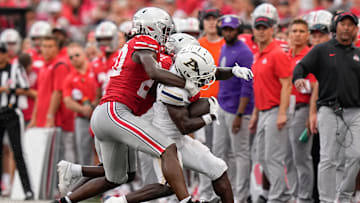 Aug 31, 2024; Columbus, OH, USA; Ohio State Buckeyes linebacker Arvell Reese (20) tackles Akron Zips wide receiver Bobby Golden (4) during the NCAA football game at Ohio Stadium. Ohio State won 52-6.