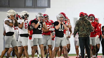 Ohio State Buckeyes huddle around head coach Ryan Day during spring football practice at the Woody Hayes Athletic Center on March 17, 2025.