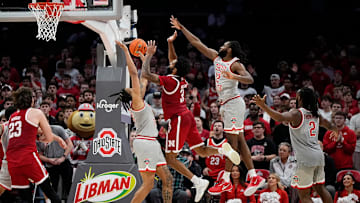 Ohio State Buckeyes forward Devin Royal (21) and guard Evan Mahaffey (12) defend Nebraska Cornhuskers guard Brice Williams (3) during the second overtime of the NCAA men's basketball game at Value City Arena in Columbus on March 4, 2025. Ohio State won 116-114.