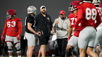Ohio State Buckeyes offensive line coach Tyler Bowen and head coach Ryan Day talk to players during spring football practice at the Woody Hayes Athletic Center in Columbus on March 19, 2025.