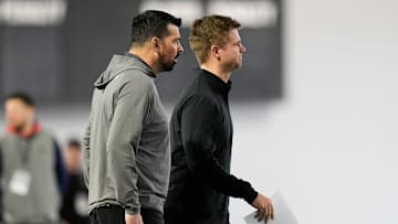 Ohio State Buckeyes head coach Ryan Day watches alongside quarterbacks coach Billy Fessler as Will Howard throws during the pro day for NFL scouts at the Woody Hayes Athletic Cente on March 26, 2025.