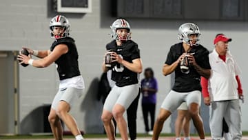 From left, Ohio State Buckeyes quarterbacks Lincoln Kienholz (3), Julian Sayin (10) and Tavien St. Clair (9) drop back to pass during spring football practice at the Woody Hayes Athletic Center in Columbus on March 19, 2025.