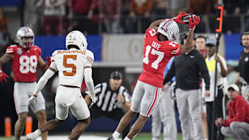 Ohio State Buckeyes wide receiver Carnell Tate (17) makes a sideline catch in front of Texas Longhorns defensive back Malik Muhammad (5) during the first half of the Cotton Bowl Classic College Football Playoff semifinal game at AT&T Stadium in Arlington, Texas on Jan. 10, 2025.