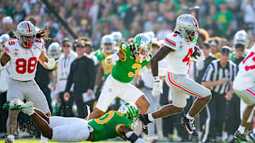 Ohio State Buckeyes wide receiver Jeremiah Smith (4) leaps past Oregon Ducks defensive back Tysheem Johnson (0) on his way to scoring a touchdown during the College Football Playoff quarterfinal at the Rose Bowl in Pasadena, Calif. on Jan. 1, 2025. Ohio State won 41-21.