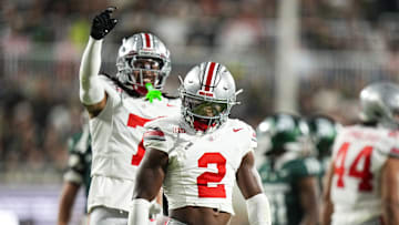 Sep 28, 2024; East Lansing, Michigan, USA; Ohio State Buckeyes safety Caleb Downs (2) celebrates after tackling Michigan State Spartans running back Nate Carter (5) in the first half at Spartan Stadium on Saturday.