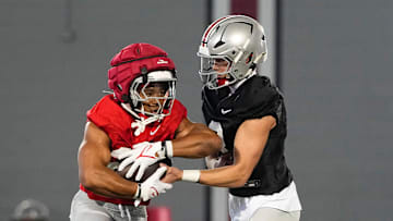Ohio State Buckeyes quarterback Lincoln Kienholz (3) hands off to running back James Peoples (20) during spring football practice at the Woody Hayes Athletic Center on March 17, 2025.