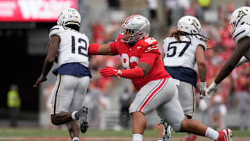 Aug 31, 2024; Columbus, OH, USA; Ohio State Buckeyes defensive tackle Hero Kanu (93) reaches to tackle Akron Zips quarterback Tahj Bullock (12) during the second half of the NCAA football game at Ohio Stadium. Ohio State won 52-6.