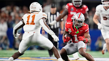Ohio State Buckeyes running back Quinshon Judkins (1) runs toward Texas Longhorns linebacker Colin Simmons (11) during the second half of the Cotton Bowl Classic College Football Playoff semifinal game at AT&T Stadium in Arlington, Texas on Jan. 10, 2025. Ohio State won 28-14.