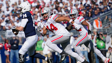 Oct 29, 2022; University Park, Pennsylvania, USA; Ohio State Buckeyes defensive end J.T. Tuimoloau (44) pursues Penn State Nittany Lions quarterback Sean Clifford (14) during the first half of the NCAA Division I football game at Beaver Stadium. Mandatory Credit: Adam Cairns-The Columbus Dispatch