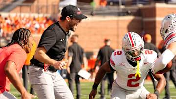Ohio State Buckeyes safeties coach Matt Guerrieri yells at defensive back Caleb Downs (2) during warm ups prior to the NCAA football game against the Illinois Fighting Illini at Gies Memorial Stadium in Champaign on Oct. 11, 2025.