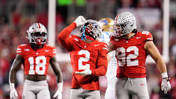 Ohio State Buckeyes defensive back Caleb Downs (2) celebrates a tackle with defensive end Caden Curry (92) and safety Jaylen McClain (18) during the NCAA football game against the UCLA Bruins at Ohio Stadium in Columbus on Nov. 15, 2025.