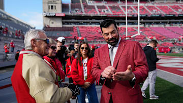 Ohio State Buckeyes head coach Ryan Day talks to former head coach and current Ohio lieutenant governor Jim Tressel prior to the NCAA football game against the Rutgers Scarlet Knights at Ohio Stadium in Columbus on Nov. 22, 2025.