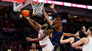 Ohio State Buckeyes guard Bruce Thornton (2) shoots around Notre Dame Fighting Irish forward Kebba Njie (14) during the men's NCAA basketball game at Value City Arena in Columbus on Nov. 16, 2025. Ohio State won 64-63.