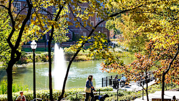 People walk by Mirror Lake on the campus of Ohio State University on Oct 24, 2024 in Columbus, Ohio.