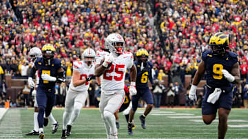 Ohio State Buckeyes running back Bo Jackson (25) runs past Michigan Wolverines defensive end Cameron Brandt (9) during the NCAA football game at Michigan Stadium in Ann Arbor, Mich. on Nov. 29, 2025. Ohio State won 27-9.
