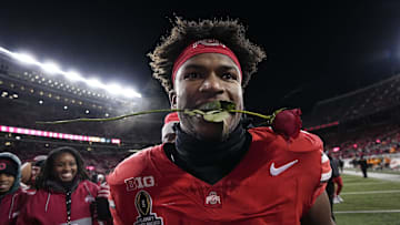 Ohio State Buckeyes safety Caleb Downs leaves the field with a rose in his mouth following the 42-17 win over the Tennessee Volunteers in the College Football Playoff first round game at Ohio Stadium in Columbus on Dec. 21, 2024. Ohio State will face Oregon in the Rose Bowl.
