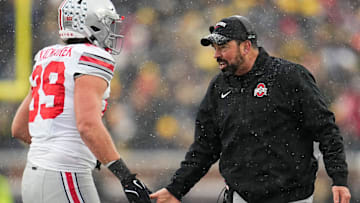 Ohio State Buckeyes head coach Ryan Day high fives tight end Will Kacmarek (89) during the NCAA football game against the Michigan Wolverines at Michigan Stadium in Ann Arbor, Mich. on Nov. 29, 2025. Ohio State won 27-9.