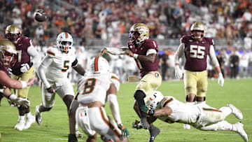 Oct 4, 2025; Tallahassee, Florida, USA; Florida State Seminoles quarterback Tommy Castellanos (1) throws against Miami Hurricanes defensive lineman Akheem Mesidor (3) during the second half at Doak S. Campbell Stadium. Mandatory Credit: Robert Myers-Imagn Images