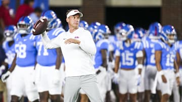 Nov 15, 2025; Oxford, Mississippi, USA; Mississippi Rebels head coach Lane Kiffin throws a football during pregame warmups against the Florida Gators at Vaught-Hemingway Stadium. Mandatory Credit: Petre Thomas-Imagn Images