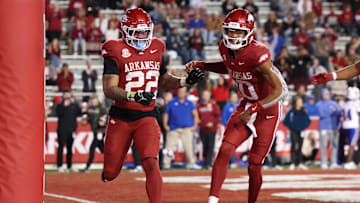 Nov 23, 2024; Fayetteville, Arkansas, USA; Arkansas Razorbacks running back Ja’Quinden Jackson (22) celebrates with quarterback Taylen Green (10) after scoring a touchdown in the fourth quarter against the Louisiana Tech Bulldogs at Donald W. Reynolds Razorback Stadium. Arkansas won 35-14. Mandatory Credit: Nelson Chenault-Imagn Images