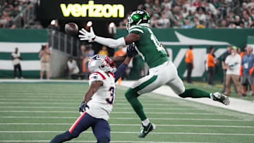Sep 19, 2024; East Rutherford, New Jersey, USA;  New York Jets wide receiver Mike Williams (18) hauls in a 2nd half pass as New England Patriots cornerback Jonathan Jones (31)  defends at MetLife Stadium. Mandatory Credit: Robert Deutsch-Imagn Images
