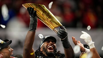Ohio State Buckeyes wide receiver Jeremiah Smith (4) holds the trophy following the 34-23 win over the Notre Dame Fighting Irish to win the College Football Playoff National Championship at Mercedes-Benz Stadium in Atlanta on Jan. 21, 2025.
