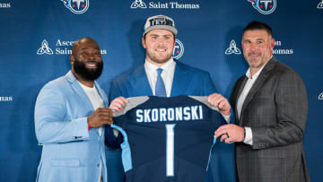 Tennessee Titans first-round draft pick offensive tackle Peter Skoronski, center, poses with general