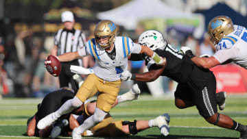 Aug 31, 2024; Honolulu, Hawaii, USA; UCLA Bruins quarterback Ethan Garbers (4) scrambles away from Hawaii Rainbow Warriors defensive lineman Dion Washington (19) during the fourth quarter of an NCAA college football game at the Clarence T.C. Ching Athletics Complex. Mandatory Credit: Marco Garcia-USA TODAY Sports