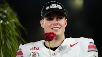 Ohio State Buckeyes quarterback Will Howard (18) holds a rose following the College Football Playoff quarterfinal against the Oregon Ducks at the Rose Bowl in Pasadena, Calif. on Jan. 1, 2025. Ohio State won 41-21.