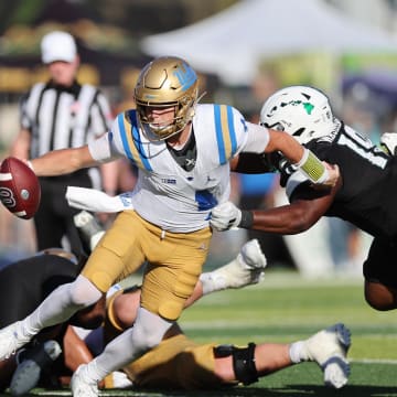 Aug 31, 2024; Honolulu, Hawaii, USA; UCLA Bruins quarterback Ethan Garbers (4) scrambles away from Hawaii Rainbow Warriors defensive lineman Dion Washington (19) during the fourth quarter of an NCAA college football game at the Clarence T.C. Ching Athletics Complex. Mandatory Credit: Marco Garcia-USA TODAY Sports