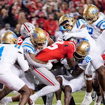 UCLA Bruins defensive back Scooter Jackson (28) tries to stop Ohio State Buckeyes running back Bo Jackson (25) during the NCAA football game at Ohio Stadium in Columbus on Nov. 15, 2025.