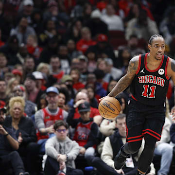 Dec 30, 2023; Chicago, Illinois, USA; Chicago Bulls forward DeMar DeRozan (11) brings the ball up court against the Philadelphia 76ers during the first half at United Center. Mandatory Credit: Kamil Krzaczynski-Imagn Images